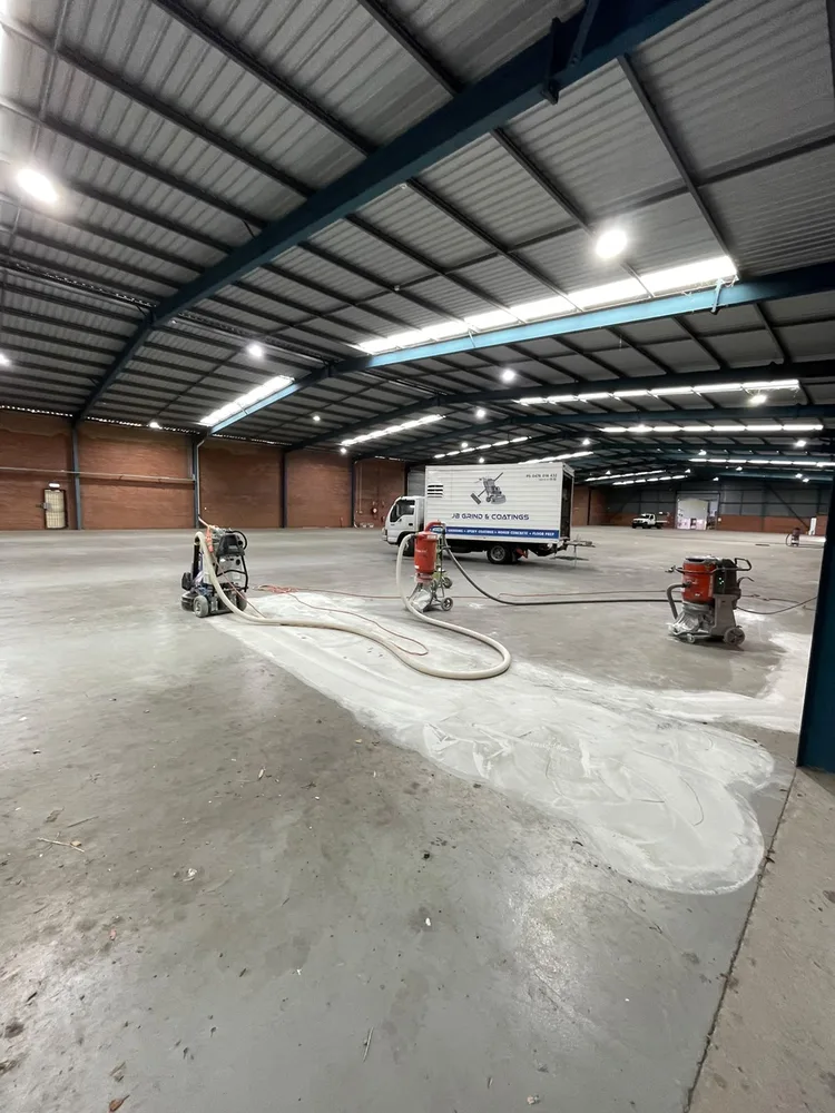 JB Grind & Coatings crew grinding a commercial warehouse slab in Perth